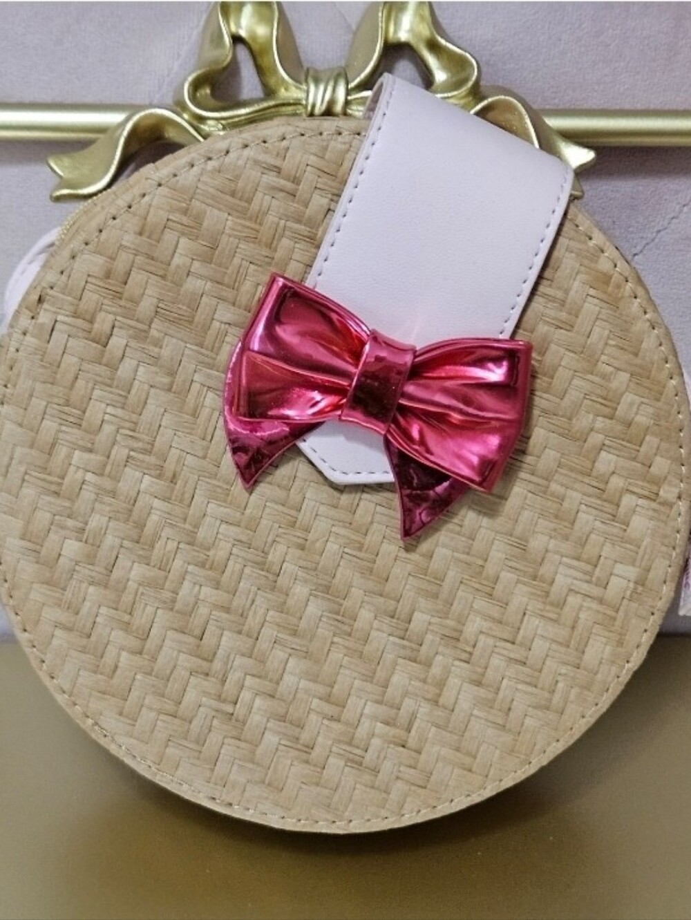 Juicy Couture Round Woven Straw Crossbody with Metallic Pink Bow
